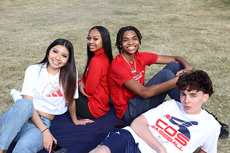 four students on grass