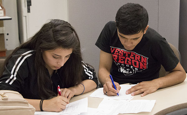 Two students working on writing