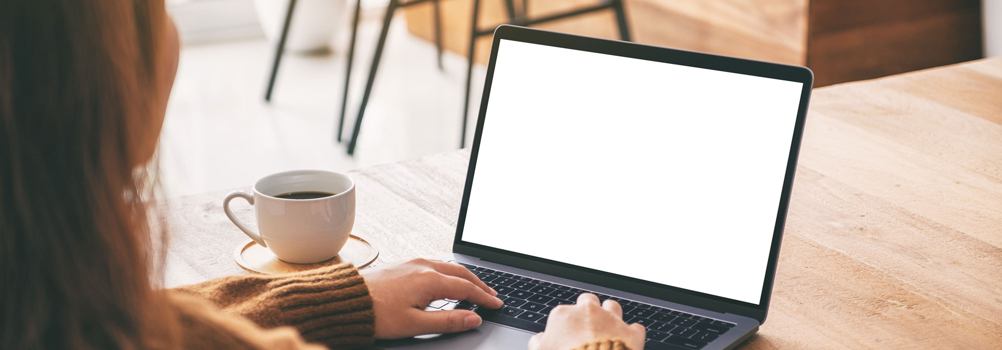 Woman sitting at table using a laptop