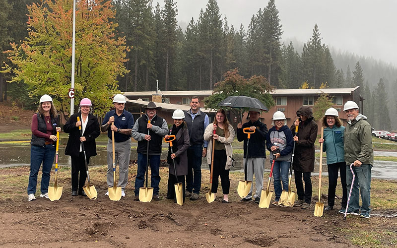 People digging ground at groundbreaking ceremony